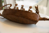 Textured bronze crocodile head detail on the antique African boat.