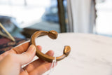 Collector antique African copper bronze snake cuff, highlighting sculpted end and rich patina.