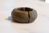 Angled view of an antique African bronze bracelet highlighting its open form and etched patterns.
