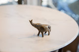 Collectible vintage African bronze elephant, displaying textured patina and raised trunk.