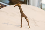 Vintage African bronze giraffe with textured surface, aged patina, and short tail.