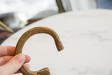 The open C-shape and detailed surface etchings of the antique African cuff.