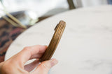 Ridged profile and etched surface details of the antique African copper bracelet.
