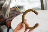 Antique African snake cuff with etched details held in hand.
