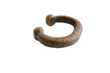 Antique African copper alloy snake cuff bracelet with a ribbed texture and rich, aged patina.