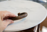Ribbed surface texture and hand-etched craftsmanship on the antique copper alloy bracelet.