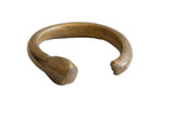 Antique African bronze snake cuff bracelet with a hand-formed shape and rich, aged patina.