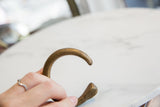 The rounded form and aged patina of an antique African bronze snake cuff.