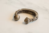Antique African aluminum cuff showing its rich, time-worn patina and unique terminals.