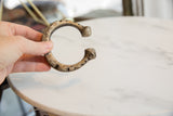 Antique African snake cuff held in hand, showing its scale and textured patina.