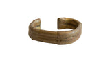 Antique African bronze cuff bracelet with a time-worn gold patina and a central braided band.