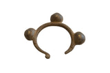 Vintage African bronze bell cuff bracelet with a textured band and three large, rounded bells.