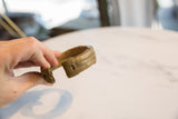 Angled profile of an antique African bronze cuff, showing its handcrafted texture and patina.