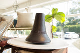 Vintage African indigo dyed wooden vase with etched geometric lines and dark purple patina.