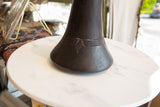 Aged African indigo-dyed wooden vase base with carved geometric lines and rich purple hue.