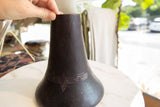 Aged indigo purple hue and hand-carved geometric pattern on the vintage wooden vase.