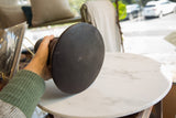 Bottom of the dark indigo-dyed wooden vase, revealing aged texture and minor imperfections.