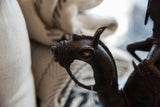 Vintage African bronze camel head, showing intricate details and dark patina.