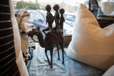 Detailed view of two vintage African bronze warriors, showcasing unique handmade features.