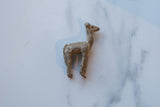 Vintage African bronze llama figurine seen from above, highlighting its rustic form and texture.