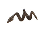 Vintage African bronze snake medallion with an undulating shape and hand-etched surface texture.
