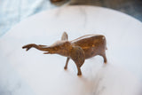 Raised trunk and aged copper texture of a vintage African elephant.