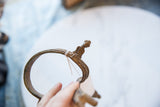 Profile view of the stylized rider figure on the vintage African bronze cuff.