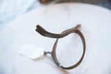 Close-up of the vintage bronze snake cuff's textured end and aged patina.