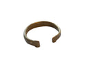Antique African bronze snake cuff bracelet with an open design and aged golden patina.