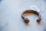A collectible antique African snake cuff bracelet with a rich copper patina.