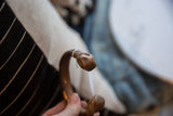 Sculpted snake head detail on the antique African copper cuff showing its aged patina.