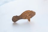 Textured details of vintage African bronze fish with light patina.