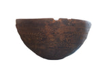 Antique African wooden bowl, deep brown, carved with geometric patterns and unique aged patina.