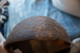 Hand-carved patterns and chipped, aged rim of the antique African wooden bowl.