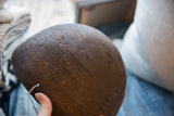 Antique African wooden bowl's dark, aged surface with etched geometric patterns.