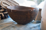Dark wood patina and hand-carved geometric patterns on the antique African bowl.