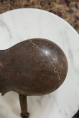Dark brown aged wood surface of the African pitcher with visible prominent crack.