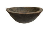 Vintage African black wooden bowl with a rustic hand-carved texture and detailed wide rim.