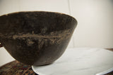 Angled detail showing the rustic, hand-worked texture of the vintage wooden bowl.