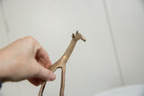 Handmade texture and vintage patina on the neck of a copper alloy giraffe figure.