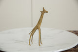 Vintage African bronze giraffe sculpture highlighting its slender form and warm, oxidized patina.