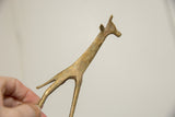 Close-up showing handmade etched patterns and the aged patina of a vintage bronze giraffe.