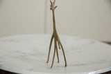 Rear view showing the slender, elongated silhouette of the bronze giraffe sculpture.