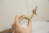 Vintage African bronze gazelle sculpture held in hand to show its collectible scale.