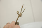 Angled close-up of the vintage gazelle's head and horns with an oxidized patina.