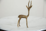 Vintage African gazelle sculpture's head, featuring detailed antlers and rich brass patina.