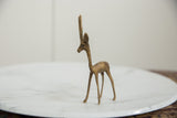 Vintage African gazelle sculpture, right facing, showcasing slender form and aged metal.