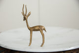 Vintage African gazelle sculpture, close-up of slender neck and textured brass antlers.