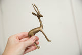 Vintage African gazelle sculpture, showing lower body and slender legs with aged patina.
