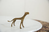 Stylized profile of the vintage African bronze cheetah highlighting its textured patina.
